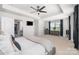 Spacious primary bedroom with a tray ceiling, TV, king bed, dual dressers and an ensuite bathroom at 355 Ladybird Ln, Pineville, NC 28134