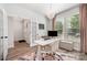 Bright office with a modern desk, stylish decor, and large windows with pink curtains, perfect for a productive workspace at 355 Ladybird Ln, Pineville, NC 28134