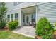 This covered patio features green bushes on a sunny day at 355 Ladybird Ln, Pineville, NC 28134