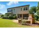 Spacious backyard featuring a patio, fireplace, and lush green lawn at 3808 Halcyon Dr, Huntersville, NC 28078