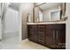 Bathroom with a large vanity features a tub and shower and custom wallpaper at 3808 Halcyon Dr, Huntersville, NC 28078