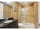 Tan-themed bathroom features a glass-enclosed shower and a stylish granite countertop vanity at 3808 Halcyon Dr, Huntersville, NC 28078