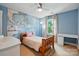 Bright bedroom features a world map mural, a wooden bed frame, and ample natural light at 3808 Halcyon Dr, Huntersville, NC 28078