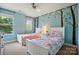 Shared ' bedroom features matching beds and a whimsical tree mural at 3808 Halcyon Dr, Huntersville, NC 28078