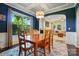 Dining room with wood table and chairs in an open concept living space with blue painted walls at 3808 Halcyon Dr, Huntersville, NC 28078