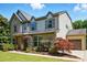 Two story home with a brick and vinyl exterior, a two car garage, and manicured landscaping at 3808 Halcyon Dr, Huntersville, NC 28078