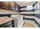 Well-organized laundry room featuring modern appliances and chic black and white striped walls at 3808 Halcyon Dr, Huntersville, NC 28078
