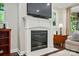 Fireplace with white mantel and hearth under television in a neutrally decorated living room at 3808 Halcyon Dr, Huntersville, NC 28078