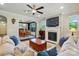 Cozy living room with a fireplace, ceiling fan and view into the dining area at 3808 Halcyon Dr, Huntersville, NC 28078