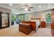 Spacious main bedroom with tray ceilings, a ceiling fan, lots of natural light, and hardwood furnishings at 3808 Halcyon Dr, Huntersville, NC 28078