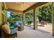 Screened-in porch with outdoor seating and a grill, surrounded by lush greenery at 3808 Halcyon Dr, Huntersville, NC 28078