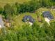 Aerial view of a beautiful home with a large, well-maintained yard, mature trees, and a long driveway at 4143 Willow Haven Dr, Denver, NC 28037