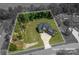 Expansive aerial view showcasing the home's architecture, manicured lawn, and surrounding lush greenery within lot lines at 4143 Willow Haven Dr, Denver, NC 28037
