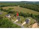 Wide aerial view of the property, nestled in a serene landscape with expansive fields and scattered homes at 4143 Willow Haven Dr, Denver, NC 28037