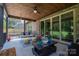 Comfortable back porch with wood plank ceiling, outdoor seating, fan and sliding doors to the home at 4143 Willow Haven Dr, Denver, NC 28037