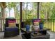 Comfortable seating area with outdoor chairs and coffee table on a covered back porch at 4143 Willow Haven Dr, Denver, NC 28037