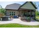 Backyard with a hot tub and covered porch, perfect for outdoor relaxation and entertaining at 4143 Willow Haven Dr, Denver, NC 28037