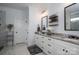 Bathroom with double vanity, modern mirror, decorative lighting, and white cabinetry at 4143 Willow Haven Dr, Denver, NC 28037