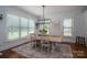 Bright dining room featuring a large window, modern lighting, and hardwood flooring at 4143 Willow Haven Dr, Denver, NC 28037