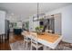 Open-concept dining room with modern lighting, and views into the kitchen and living room at 4143 Willow Haven Dr, Denver, NC 28037