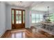 Entryway with stained-glass front door leading into dining room with modern light fixture and natural light at 4143 Willow Haven Dr, Denver, NC 28037