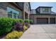 Close-up of a brick home featuring a paved driveway and beautiful landscaping around the front yard at 4143 Willow Haven Dr, Denver, NC 28037