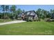 Charming two-story brick home featuring a well-manicured lawn and a basketball hoop on a long driveway at 4143 Willow Haven Dr, Denver, NC 28037