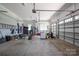 Spacious garage with ample storage, utility sink, and multiple garage door openings at 4143 Willow Haven Dr, Denver, NC 28037