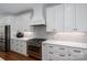 Modern kitchen with white cabinetry, stainless steel appliances, subway tile backsplash, and hardwood floors at 4143 Willow Haven Dr, Denver, NC 28037
