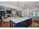 Open-concept kitchen with a center island, modern appliances, and easy access to the living room and dining area at 4143 Willow Haven Dr, Denver, NC 28037