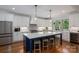Modern kitchen featuring white cabinets, an island with seating, and stainless steel appliances at 4143 Willow Haven Dr, Denver, NC 28037
