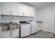 Bright laundry room with modern washer and dryer and custom cabinetry at 4143 Willow Haven Dr, Denver, NC 28037