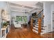 Open-concept living room boasts coffered ceilings, hardwood floors, a fireplace, and a staircase at 4143 Willow Haven Dr, Denver, NC 28037