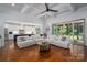 Open-concept living space with hardwood floors, a large sofa, and a seamless transition to the kitchen at 4143 Willow Haven Dr, Denver, NC 28037