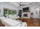 A cozy living room with stone fireplace, large sliding glass door, and comfortable white seating at 4143 Willow Haven Dr, Denver, NC 28037
