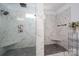 Luxurious walk-in shower with dual shower heads, marble tiling, and a built-in bench at 4143 Willow Haven Dr, Denver, NC 28037