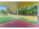 A covered wooden porch offers a view of the lawn and wooded area at 4499 Briarcreek Rd, Maiden, NC 28650