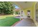 Covered back porch with brick trim, a view of the yard, and an entry door at 4499 Briarcreek Rd, Maiden, NC 28650