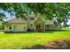 Backyard view of home with large grassy area and covered patio at 4499 Briarcreek Rd, Maiden, NC 28650