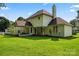 Spacious backyard featuring a yellow-sided home with a covered patio and a well-manicured lawn at 4499 Briarcreek Rd, Maiden, NC 28650
