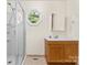 Bright bathroom features a glass-enclosed shower and a window view at 4499 Briarcreek Rd, Maiden, NC 28650