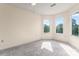 Bright bedroom featuring plush carpet, neutral walls, and natural light from two windows at 4499 Briarcreek Rd, Maiden, NC 28650