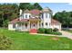 Inviting two-story home featuring a charming front porch and well-maintained landscaping at 4499 Briarcreek Rd, Maiden, NC 28650