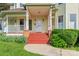 Welcoming front porch with red stairs, white railing, and beautiful landscaping at 4499 Briarcreek Rd, Maiden, NC 28650