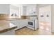 Cozy kitchen featuring white cabinets, tile countertops, and tile backsplash at 4499 Briarcreek Rd, Maiden, NC 28650