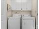 Functional laundry room with washer, dryer, and overhead cabinets at 4499 Briarcreek Rd, Maiden, NC 28650