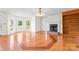 Bright living room features hardwood floors, a fireplace, built-in shelving and large windows for ample natural light at 4499 Briarcreek Rd, Maiden, NC 28650