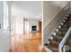 Inviting living room showcasing hardwood floors, fireplace, and stairway access at 4499 Briarcreek Rd, Maiden, NC 28650