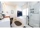 Bright bathroom featuring a soaking tub, glass-enclosed shower, and neutral decor at 4683 Dunberry Sw Pl, Concord, NC 28027
