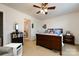 A cozy bedroom features neutral carpet, a wood bed frame and a doorway that leads to an ensuite bathroom at 4683 Dunberry Sw Pl, Concord, NC 28027